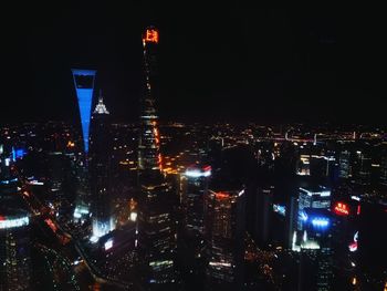 Illuminated cityscape against sky at night