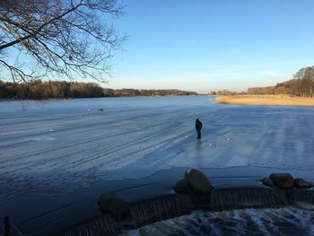 Scenic view of frozen lake against clear blue sky