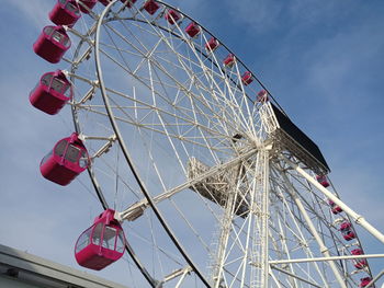 Low angle view of ferris wheel against sky