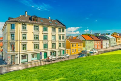 Houses on field against sky