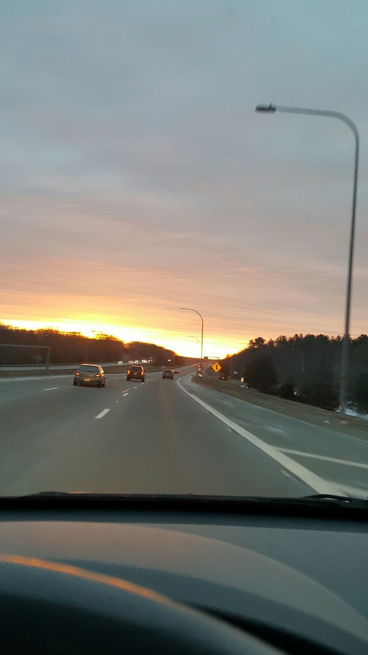 CARS ON ROAD AGAINST SKY