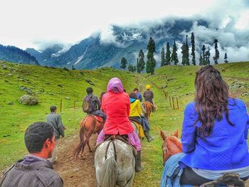 Tourists on grassy field