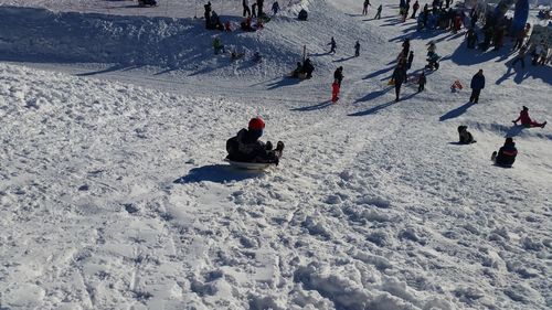 High angle view of people on snow covered land