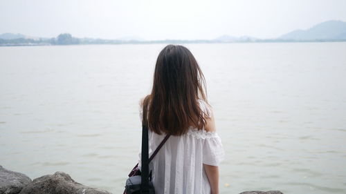 Rear view of woman looking at sea