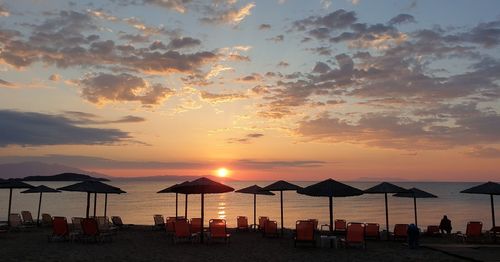 Scenic view of beach against sky during sunset