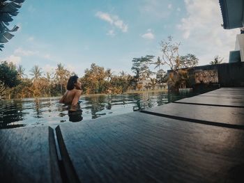 Rear view of man in swimming pool