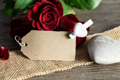 Close-up of red rose on table