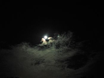 Low angle view of illuminated lights against sky at night