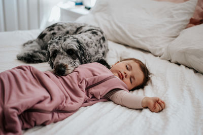 Close-up of dog sleeping on bed at home