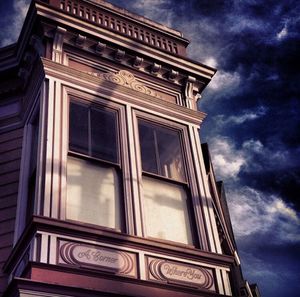 Low angle view of building against cloudy sky