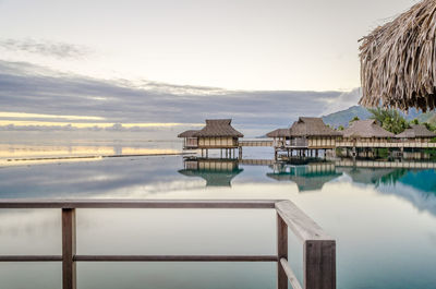 Built structure on sea against cloudy sky