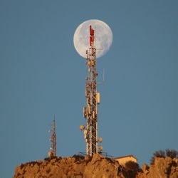 Low angle view of communications tower against clear sky