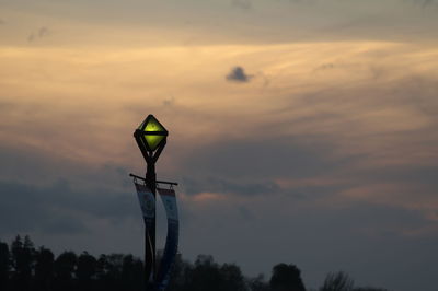 Low angle view of basketball hoop against sky during sunset