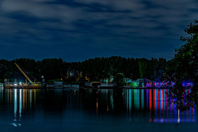 Scenic view of lake against sky at night