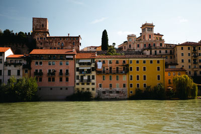 View of old town bassano del grappa from river with moody daylight.