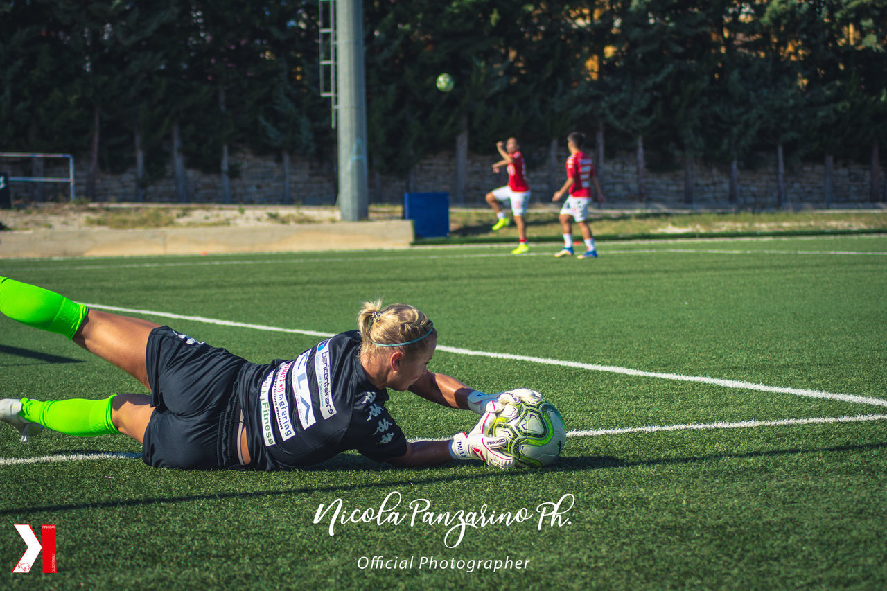 FRIENDS PLAYING SOCCER ON FIELD