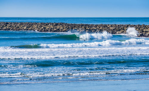 Waves roll in along the jetty in westport, washington.