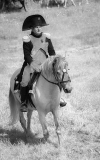 Man riding horse on field