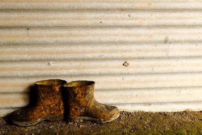 Close-up of shoes on rusty metal