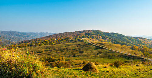 Scenic view of mountains against clear blue sky
