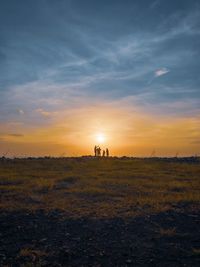 Scenic view of field against sky during sunset