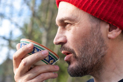 Close-up portrait of man holding baby outdoors