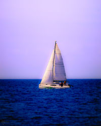 Sailboat sailing in sea against sky