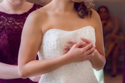 Midsection of bride in dress