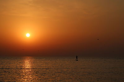 Scenic view of sea against orange sky