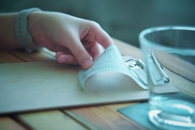 Cropped hand of person holding book