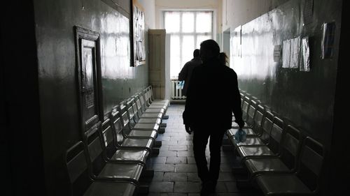 Rear view of woman walking in corridor