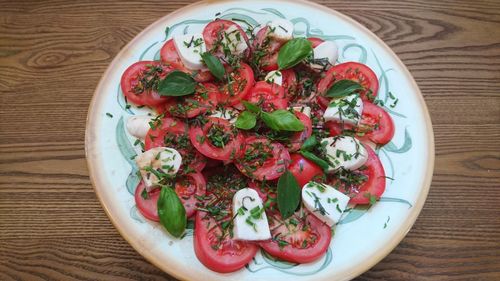 High angle view of caprese salad in plate on table