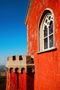 Low angle view of building against clear blue sky