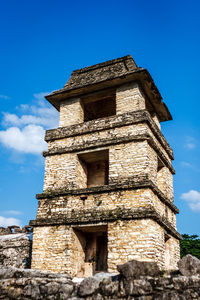 Low angle view of old temple against blue sky