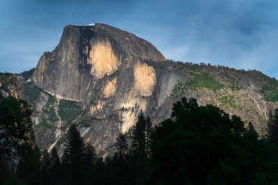 Low angle view of sun shining through rocks