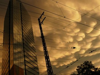 Low angle view of electricity pylon against sky