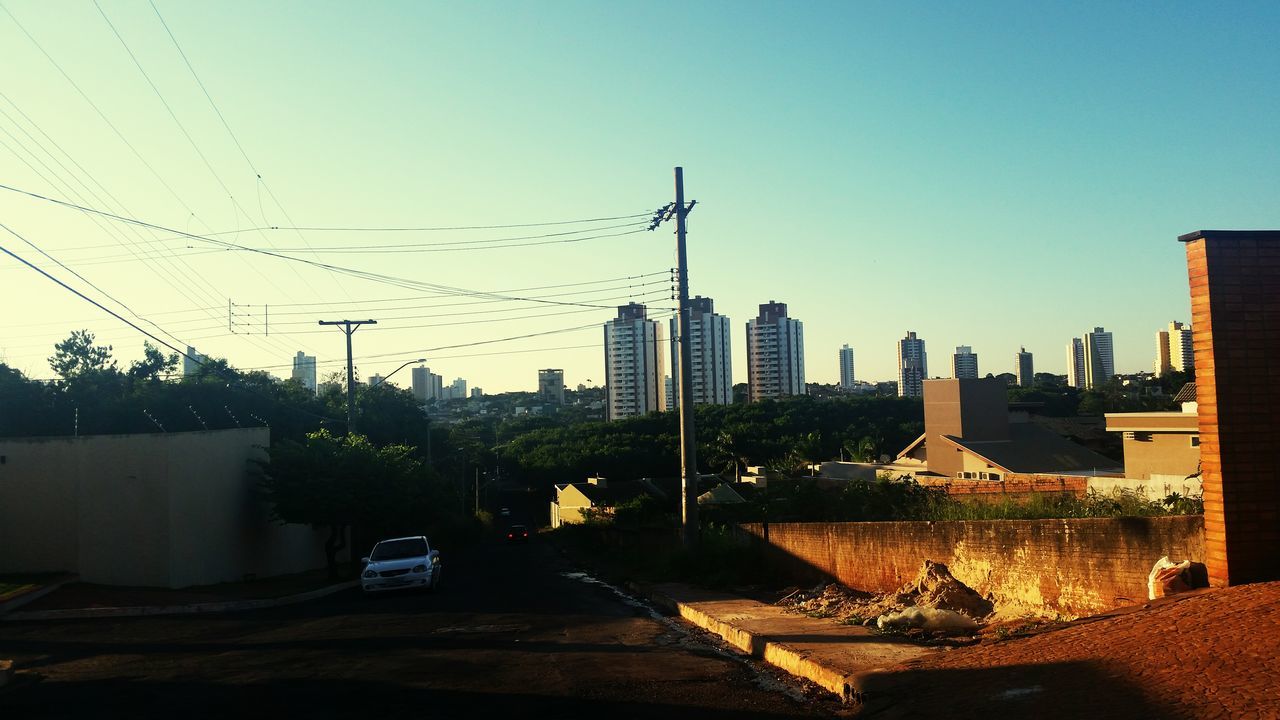 building exterior, architecture, built structure, clear sky, copy space, city, cityscape, residential structure, tower, building, outdoors, sky, development, residential building, no people, construction site, day, sunlight, crane - construction machinery, fuel and power generation