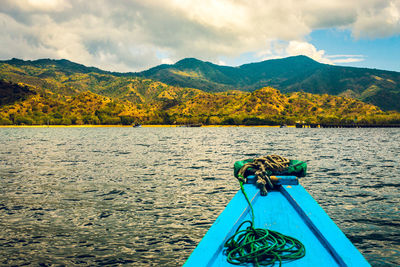 Boat in lake against mountains