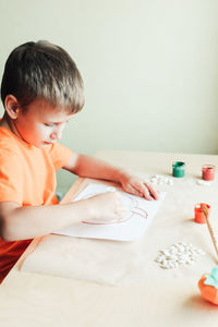 Cute boy playing on table