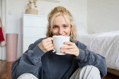 Portrait of young woman using mobile phone