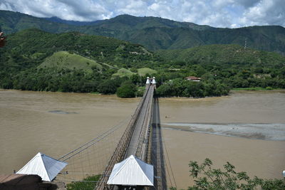 High angle view of bridge and mountains against sky