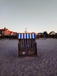 Lifeguard hut on beach against clear sky