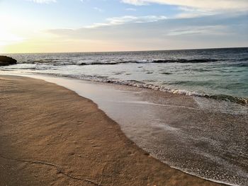 Scenic view of beach against sky during sunset