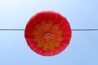 Low angle view of lantern against clear blue sky