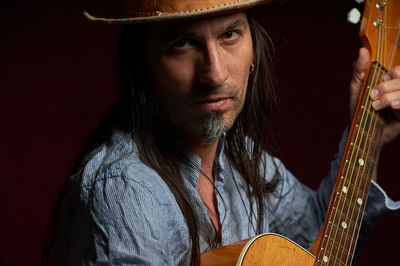 Portrait of young man playing guitar