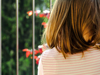 My daughter is a beautiful little girl photographed from the back while playing and is carefree