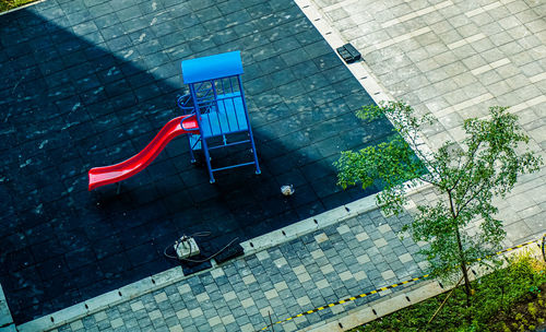 High angle view of empty chairs against wall in city