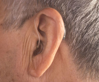 Close-up of man with hearing aid