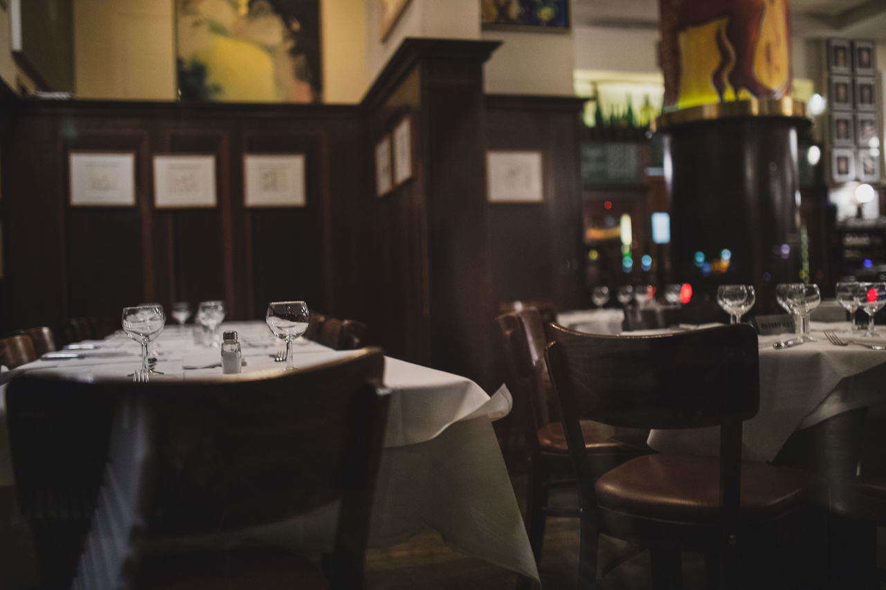 EMPTY CHAIRS AND TABLES AT RESTAURANT