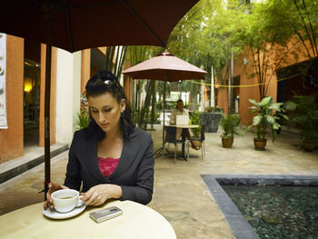 Businesswoman having coffee at cafe